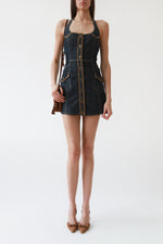 Dark denim Burberry London halterneck mini dress with open back, button-front closure, patch pockets, and A-line skirt