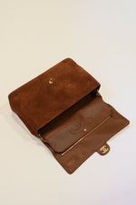Double flap leather interior of Chanel camel/cognac suede Souplissimo Maxi Flap bag with CC logo stitched into second interior flap with button closure and a zipper pocket on interior of outermost flap 