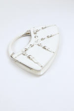 Rotated side view of Christian Dior White Bondage Patent Leather Mini Bag with Silver Hardware and Bondage Buckle Clip Details