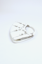 Side view of Christian Dior White Bondage Patent Leather Mini Bag with Silver Hardware and Bondage Buckle Clip Details
